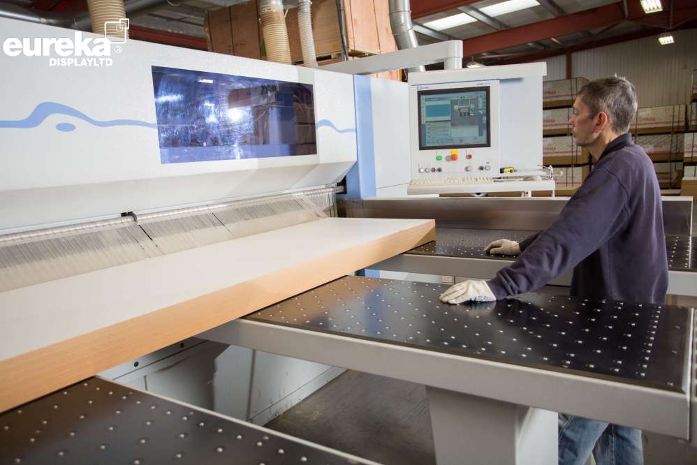 A man waiting for the boards to be cut precisely