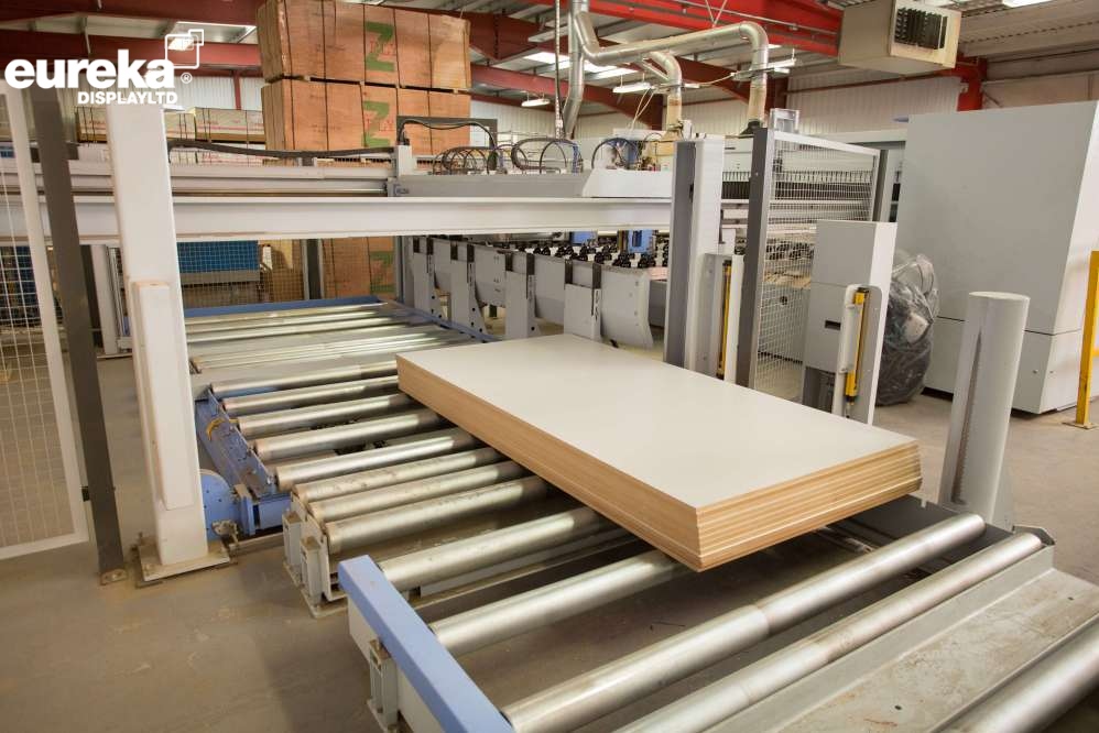 Finely cut wood traveling down a conveyor belt
