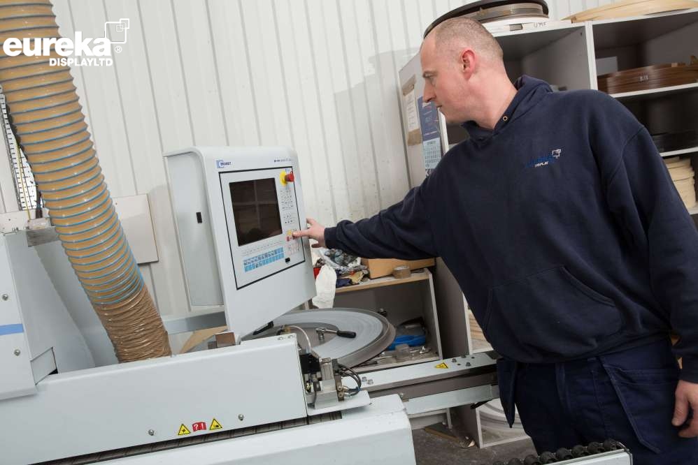 A man using the Baz machine computer for it to produce a panel product